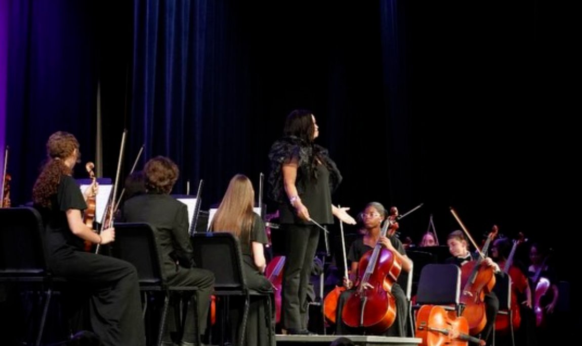 Ms. Bradby addressing the orchestra