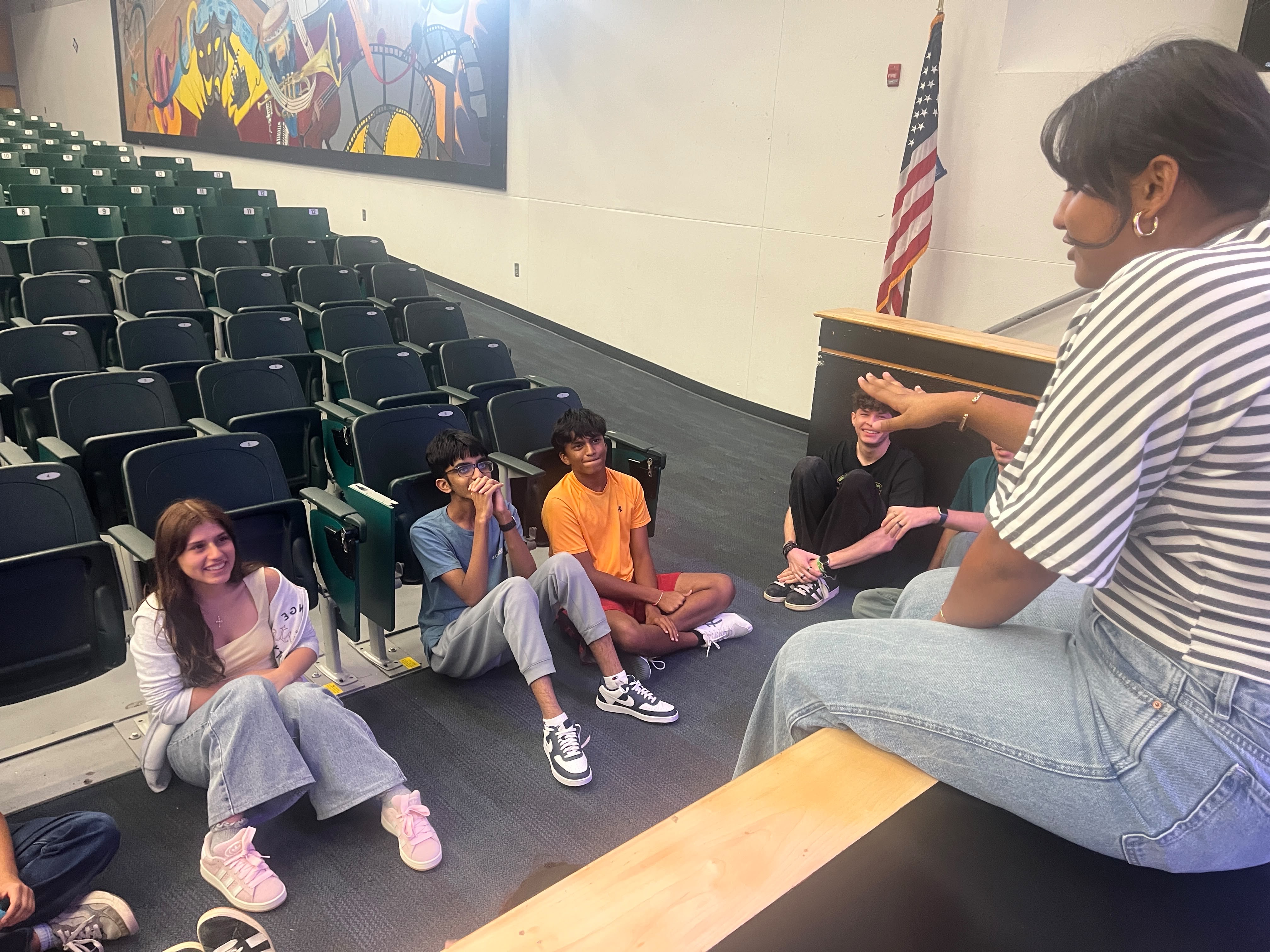 Orchestra students playing games together in the auditorium